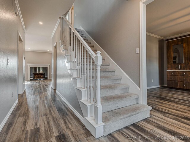 15412 E 78th St N, Owasso, OK 74055 - staircase featuring crown molding, wood finished floors, baseboards, and a fireplace