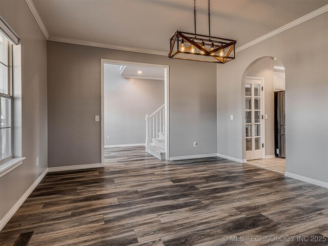 15412 E 78th St N, Owasso, OK 74055 - unfurnished dining area with arched walkways, dark wood-type flooring, crown molding, baseboards, and stairway