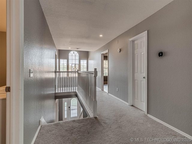15412 E 78th St N, Owasso, OK 74055 - hallway with a textured wall, an upstairs landing, carpet floors, a textured ceiling, and baseboards