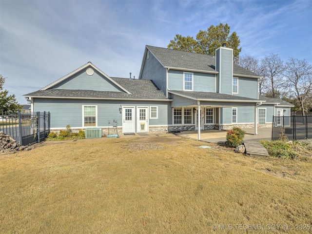 15412 E 78th St N, Owasso, OK 74055 - rear view of house featuring central AC unit, a chimney, a patio, a shingled roof, and stone siding