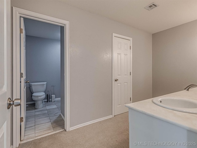 15412 E 78th St N, Owasso, OK 74055 - bathroom featuring toilet, baseboards, and vanity
