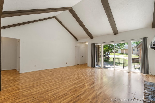 3901 E 60th Pl, Tulsa, OK 74135 - unfurnished living room featuring light wood-style floors, beamed ceiling, high vaulted ceiling, and baseboards