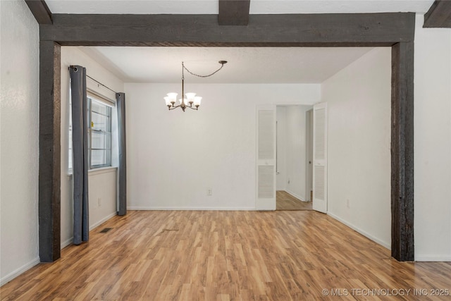 3901 E 60th Pl, Tulsa, OK 74135 - spare room featuring light wood-style floors, a chandelier, baseboards, and beamed ceiling