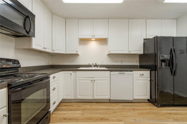 3901 E 60th Pl, Tulsa, OK 74135 - kitchen with black appliances, a sink, and white cabinetry