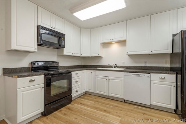 3901 E 60th Pl, Tulsa, OK 74135 - kitchen with black appliances, a sink, white cabinetry, light wood-style floors, and dark countertops