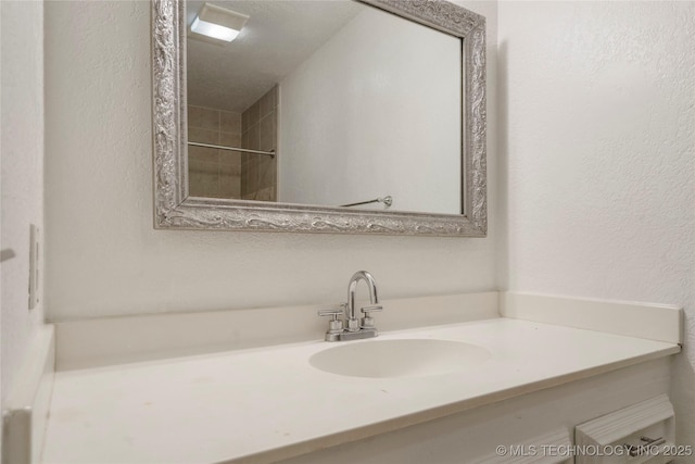 3901 E 60th Pl, Tulsa, OK 74135 - bathroom featuring vanity and a textured wall