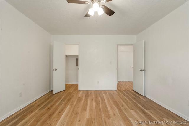 3901 E 60th Pl, Tulsa, OK 74135 - unfurnished bedroom with light wood-style flooring, baseboards, and a ceiling fan