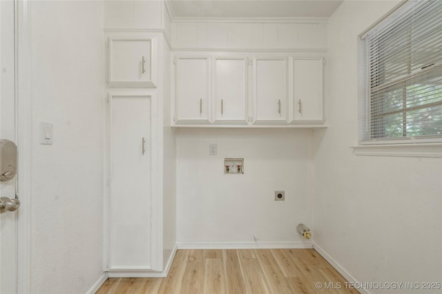 3901 E 60th Pl, Tulsa, OK 74135 - laundry room with hookup for a washing machine, hookup for an electric dryer, light wood-type flooring, baseboards, and cabinet space