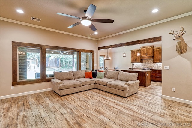 117683 Powell Rd, Eufaula, OK 74432 - living room featuring crown molding, a ceiling fan, light wood-style flooring, recessed lighting, and baseboards