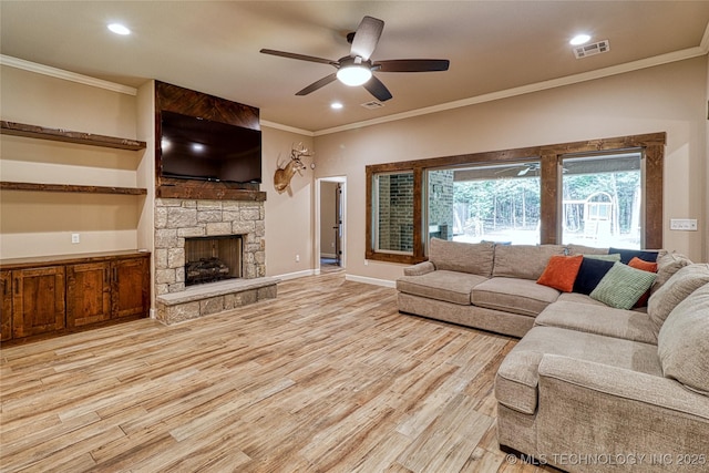 117683 Powell Rd, Eufaula, OK 74432 - living room featuring crown molding, light wood finished floors, ceiling fan, a stone fireplace, and baseboards