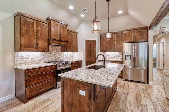 117683 Powell Rd, Eufaula, OK 74432 - kitchen featuring appliances with stainless steel finishes, a sink, light wood-type flooring, light stone counters, and lofted ceiling