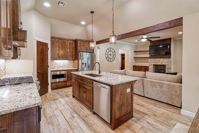 117683 Powell Rd, Eufaula, OK 74432 - kitchen featuring appliances with stainless steel finishes, a sink, light wood-style floors, a ceiling fan, and hanging light fixtures
