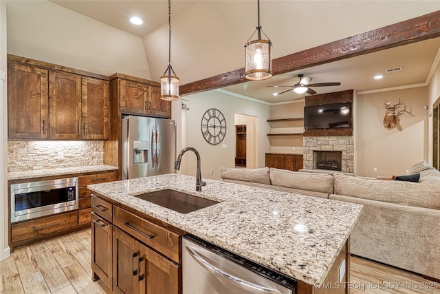 117683 Powell Rd, Eufaula, OK 74432 - kitchen featuring stainless steel appliances, a sink, a fireplace, ornamental molding, and a ceiling fan