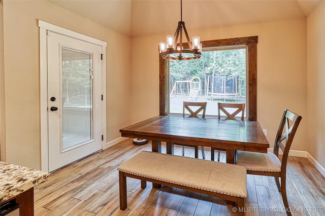 117683 Powell Rd, Eufaula, OK 74432 - dining area featuring vaulted ceiling, a chandelier, light wood finished floors, and baseboards