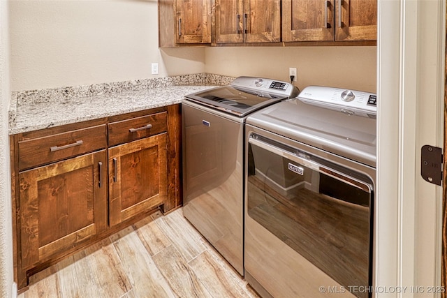 117683 Powell Rd, Eufaula, OK 74432 - laundry room with cabinet space, washing machine and clothes dryer, and light wood-style floors