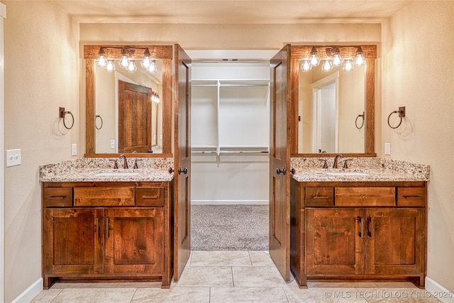 117683 Powell Rd, Eufaula, OK 74432 - full bathroom with two vanities, a spacious closet, baseboards, and a textured wall