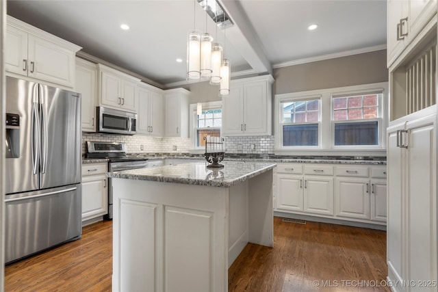 kitchen featuring stainless steel appliances, crown molding, white cabinets, tasteful backsplash, and recessed lighting