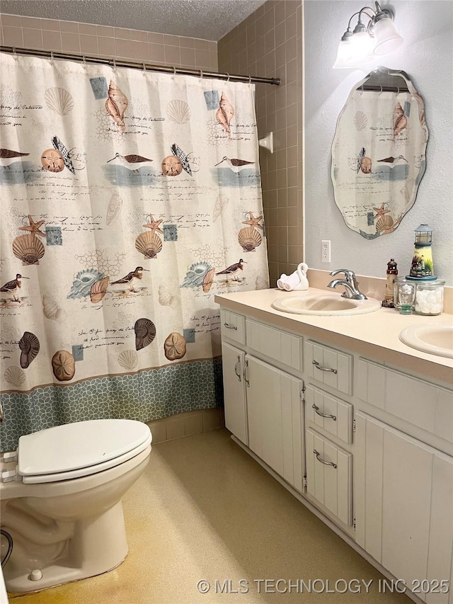 full bathroom with toilet, double vanity, a shower with curtain, and a textured ceiling