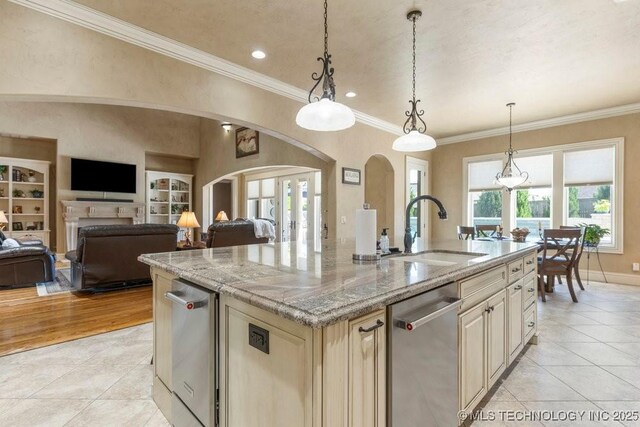 716 W 108th Pl S, Jenks, OK 74037 - kitchen featuring a sink, light tile patterned floors, open floor plan, a center island with sink, and built in shelves