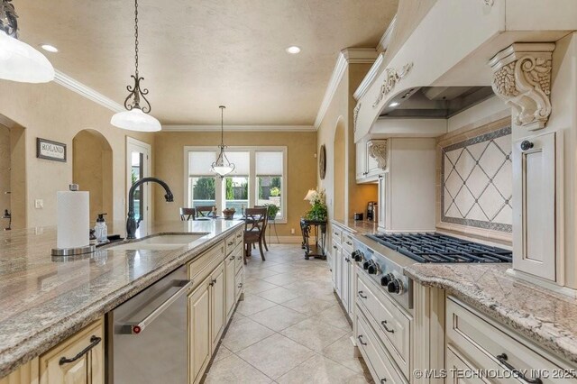 716 W 108th Pl S, Jenks, OK 74037 - kitchen with a sink, appliances with stainless steel finishes, arched walkways, tasteful backsplash, and crown molding