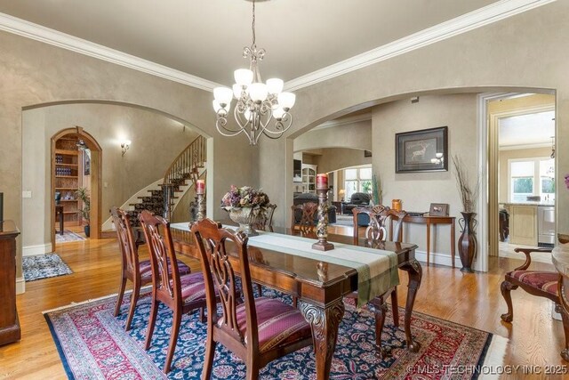 716 W 108th Pl S, Jenks, OK 74037 - dining room with arched walkways, healthy amount of natural light, wood finished floors, and ornamental molding