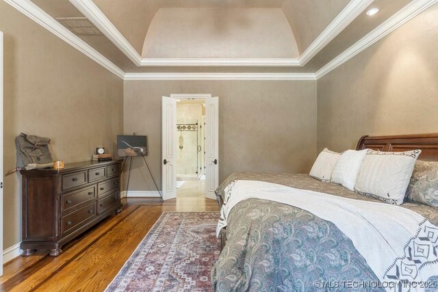 716 W 108th Pl S, Jenks, OK 74037 - bedroom with wood finished floors, a raised ceiling, crown molding, baseboards, and ensuite bathroom