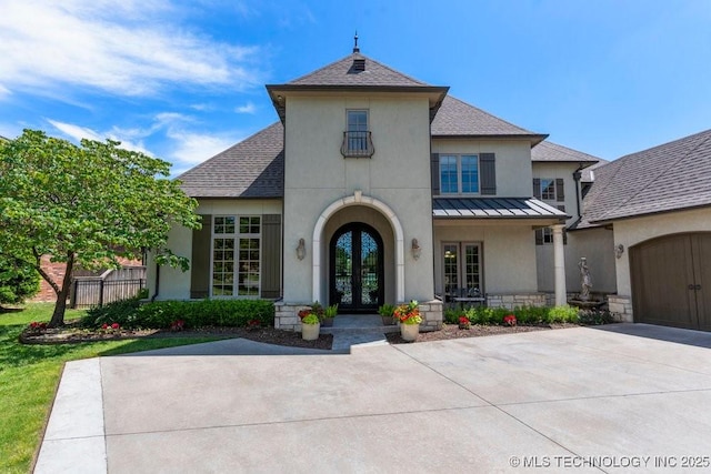 716 W 108th Pl S, Jenks, OK 74037 - view of front of property featuring french doors, a standing seam roof, stucco siding, and roof with shingles