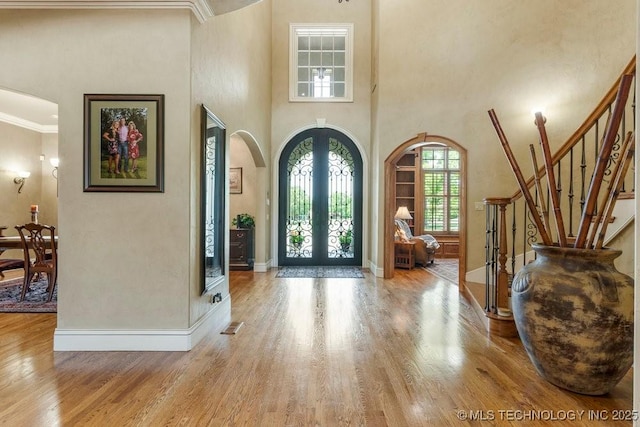 716 W 108th Pl S, Jenks, OK 74037 - entryway with arched walkways, stairs, wood finished floors, french doors, and a high ceiling