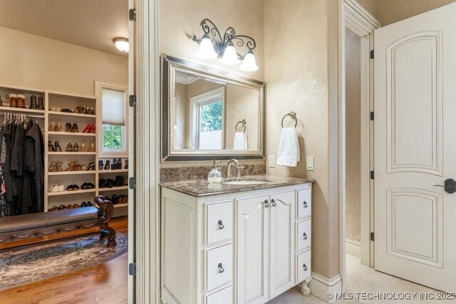 716 W 108th Pl S, Jenks, OK 74037 - bathroom with vanity and a walk in closet