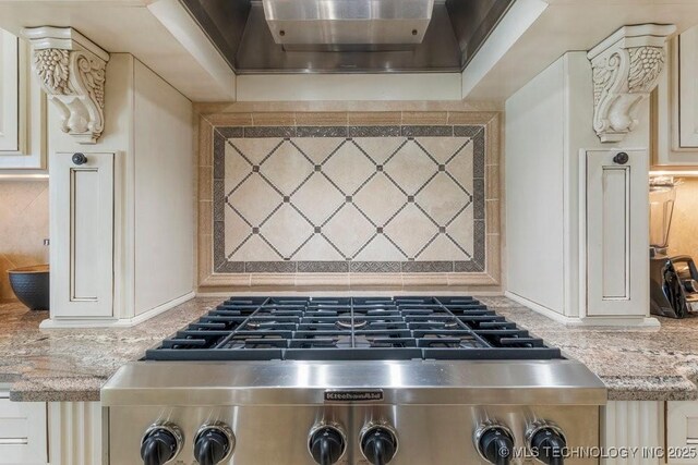 716 W 108th Pl S, Jenks, OK 74037 - kitchen featuring cream cabinets, wall chimney range hood, and light stone countertops