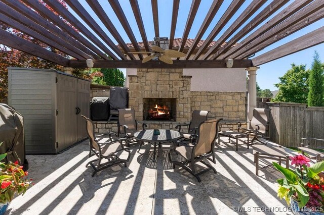 716 W 108th Pl S, Jenks, OK 74037 - view of patio featuring an outdoor stone fireplace, fence, a ceiling fan, and a pergola