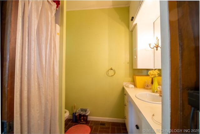 bathroom with baseboards and vanity