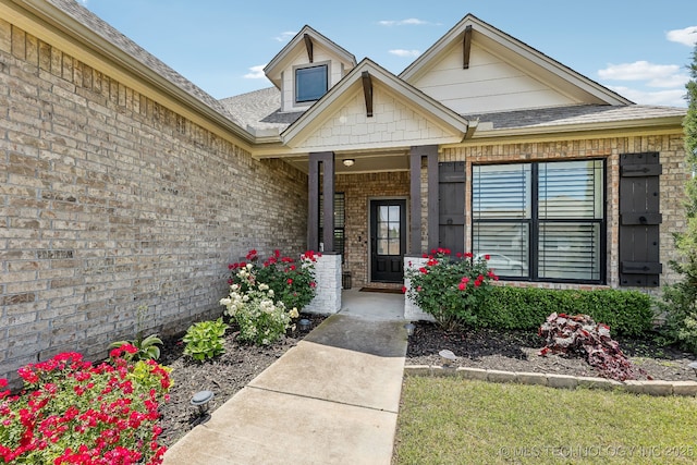 entrance to property with brick siding and covered porch