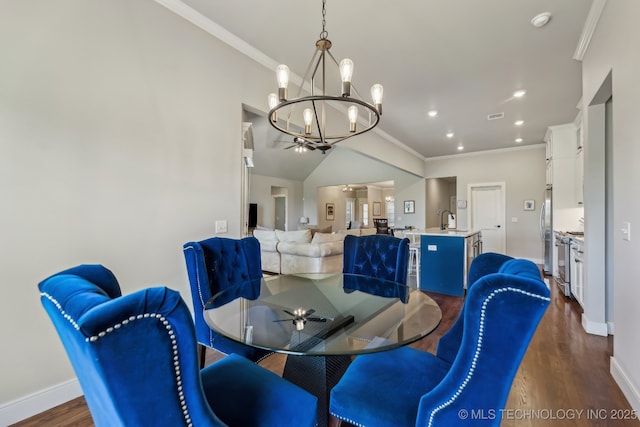 dining space featuring a chandelier, dark wood-type flooring, crown molding, baseboards, and recessed lighting