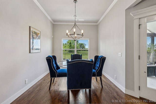 dining area featuring dark wood finished floors, baseboards, a chandelier, and crown molding