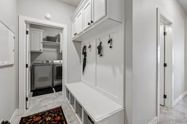 mudroom with independent washer and dryer and baseboards