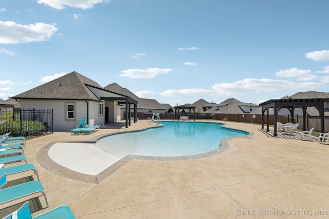 community pool featuring a patio, fence, and a gazebo