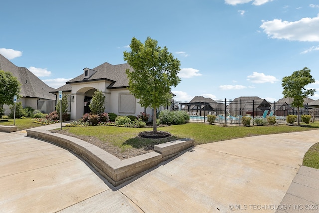 view of front of home with stucco siding and a shingled roof