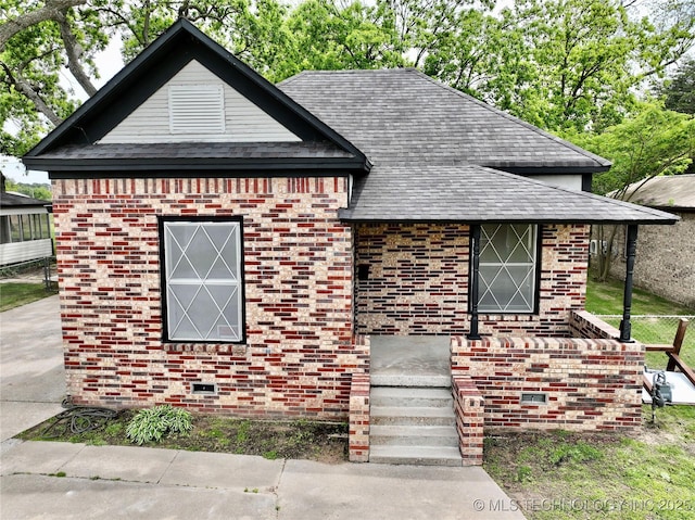 216 Belt Ave, Eufaula, OK 74432 - view of front facade featuring brick siding and a shingled roof