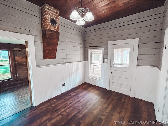 216 Belt Ave, Eufaula, OK 74432 - foyer entrance featuring dark wood-style floors, a chandelier, and wooden walls