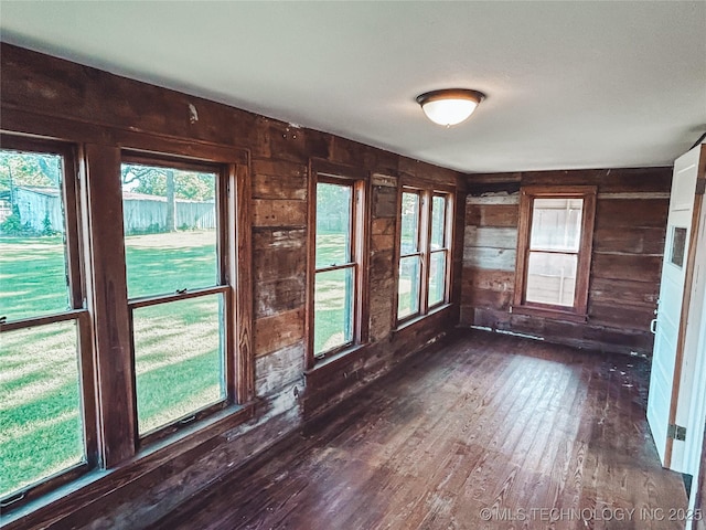 216 Belt Ave, Eufaula, OK 74432 - unfurnished room featuring wood walls, dark wood-type flooring, and plenty of natural light