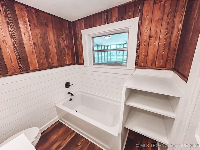 216 Belt Ave, Eufaula, OK 74432 - full bathroom with toilet, a garden tub, wood walls, and wood finished floors