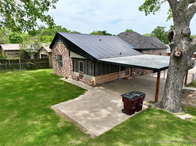 216 Belt Ave, Eufaula, OK 74432 - rear view of house featuring a carport, stone siding, metal roof, and a sunroom