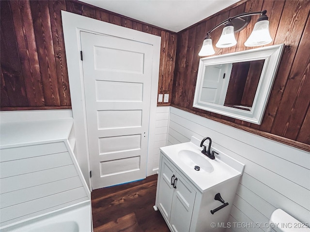 216 Belt Ave, Eufaula, OK 74432 - bathroom featuring wood walls, vanity, wood finished floors, and a tub