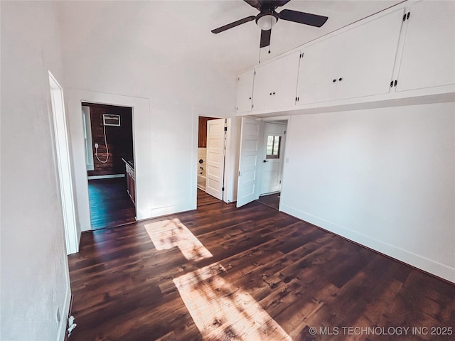 216 Belt Ave, Eufaula, OK 74432 - spare room featuring baseboards, ceiling fan, a towering ceiling, and dark wood-style flooring
