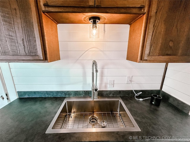 216 Belt Ave, Eufaula, OK 74432 - kitchen view of a sink, dark countertops, and brown cabinets