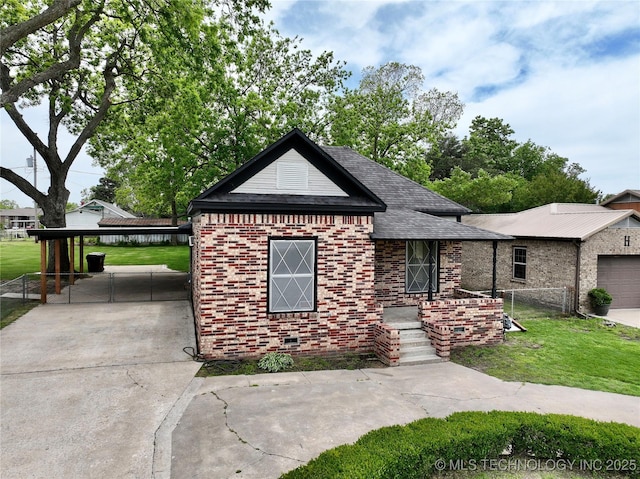 216 Belt Ave, Eufaula, OK 74432 - view of front facade with brick siding, driveway, a shingled roof, and a detached carport