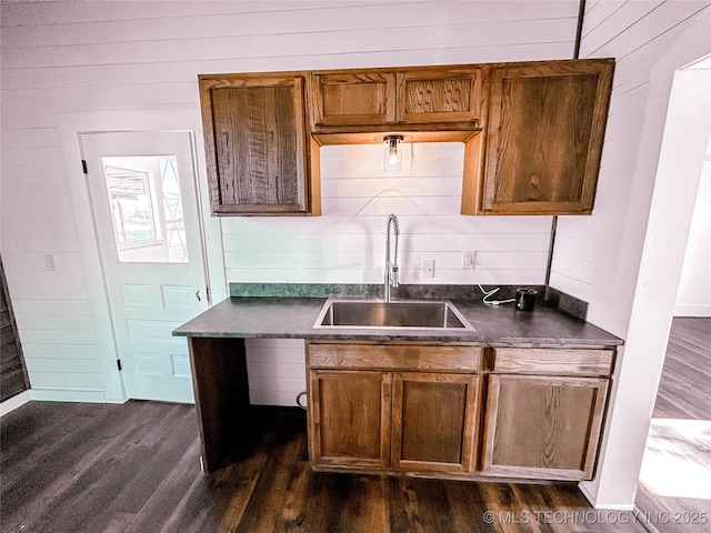 216 Belt Ave, Eufaula, OK 74432 - kitchen featuring a sink, dark countertops, dark wood-style floors, and brown cabinetry