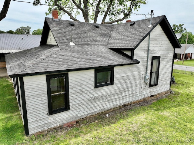 216 Belt Ave, Eufaula, OK 74432 - rear view of house featuring a yard, roof with shingles, and a chimney