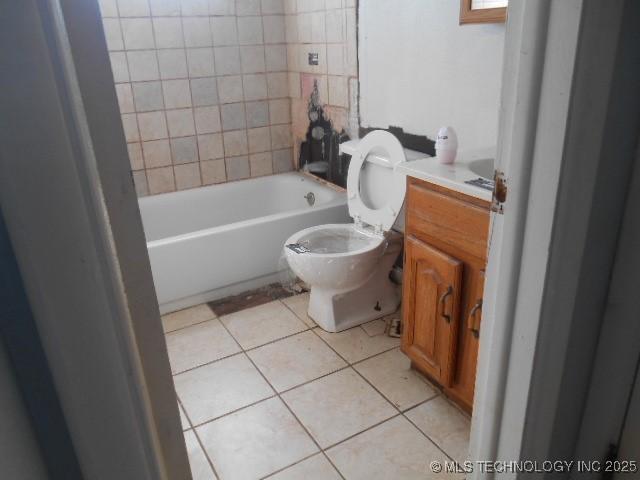 bathroom featuring tile patterned flooring, toilet, and vanity